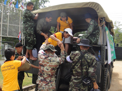 VMs arrive at a flood relief coordination site manned by the Thai army.
